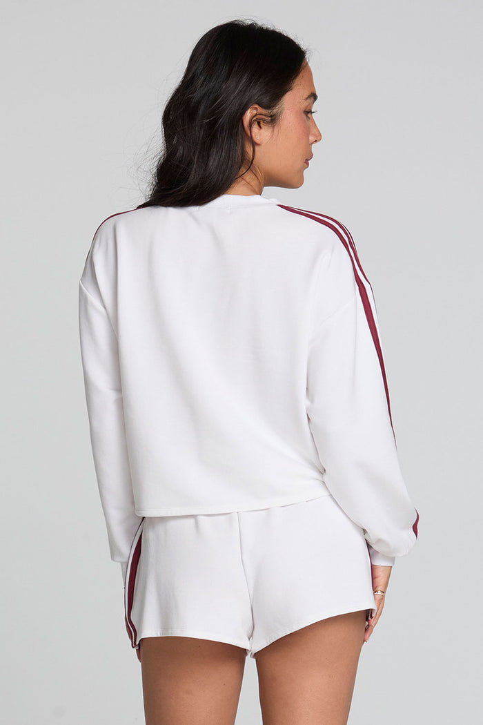 Back view of a woman wearing the Chaser Kloud Cloud White Sweatshirt Set on a neutral background with matching white shorts