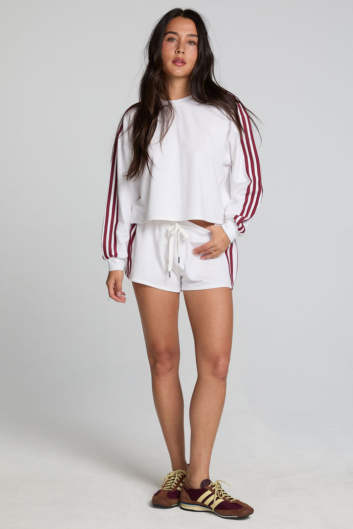 A full body front view of a woman wearing the Chaser Kloud Cloud White Sweatshirt on a neutral background