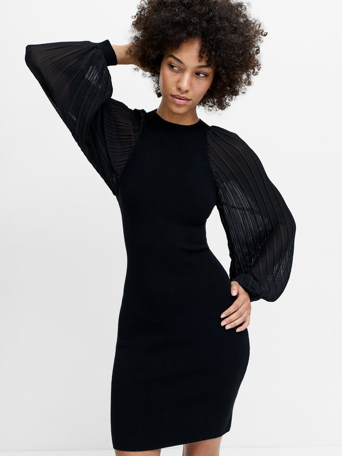 A woman wearing a black body-con dress with pleated sheer balloon sleeves, a crew neck and a fitted silhouette.
