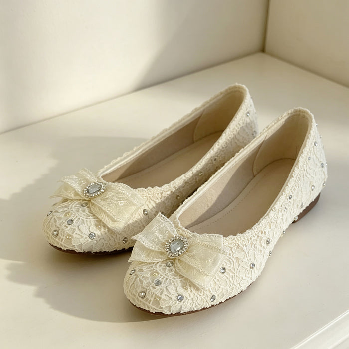 Lace bridal flats with crystal bow and rhinestone details handcrafted for elegant wedding shoes and bridal styling.