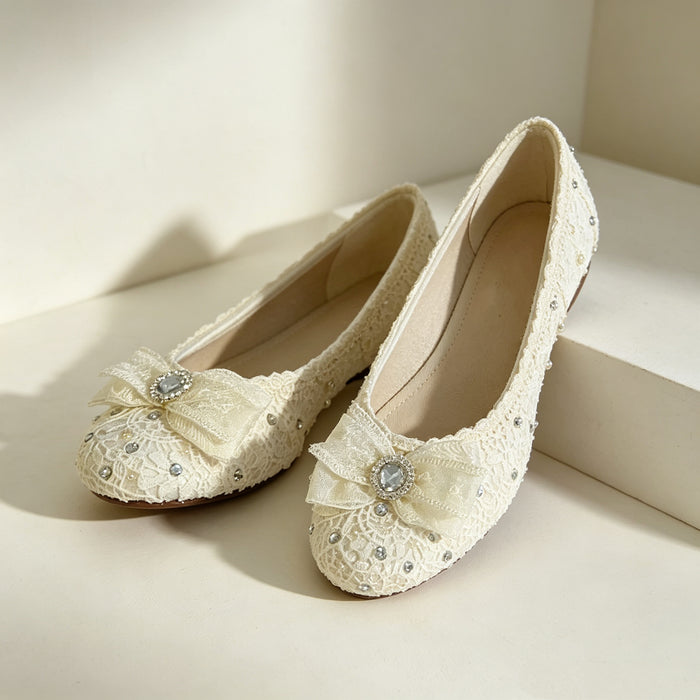 Lace bridal flats with crystal bow and rhinestone details handcrafted for elegant wedding shoes and bridal styling.