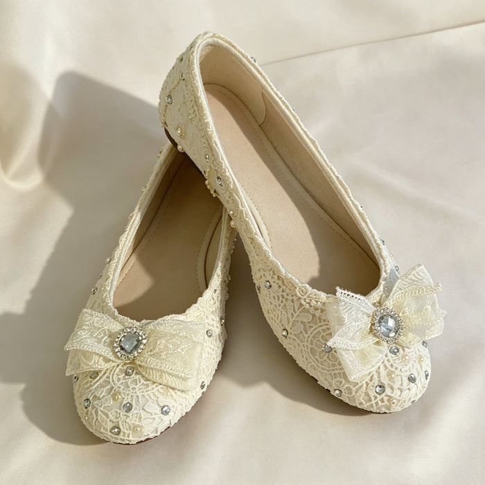 Lace bridal flats with crystal bow and rhinestone details handcrafted for elegant wedding shoes and bridal styling.