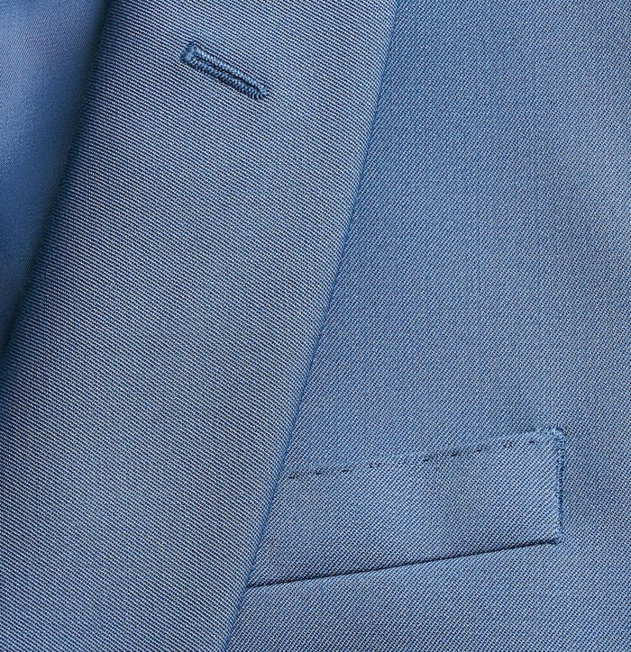 Close-up of lake blue tuxedo jacket lapel, buttonhole, and welt pocket