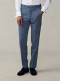 Cropped front view of lake blue tuxedo trousers with navy velvet loafers