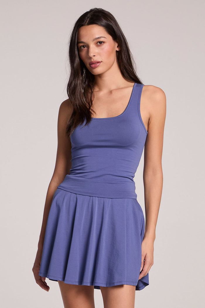 Front view of a woman wearing the Chaser French Riviera Lander Tank and matching skirt  on a neutral background