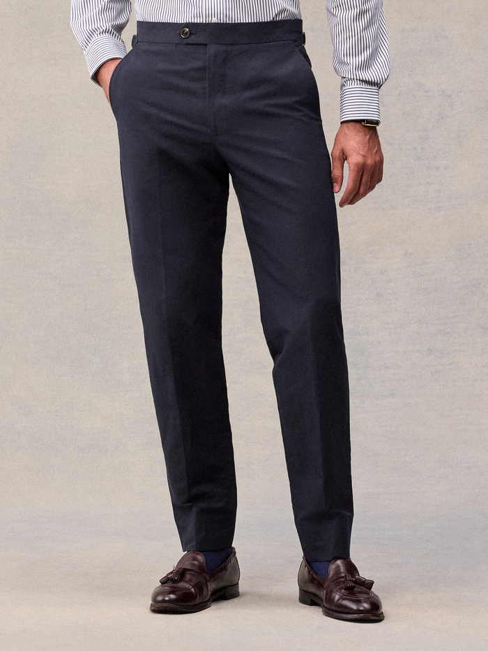Deepwater navy linen trousers with side-adjuster tabs, cropped waist-to-shoe view.