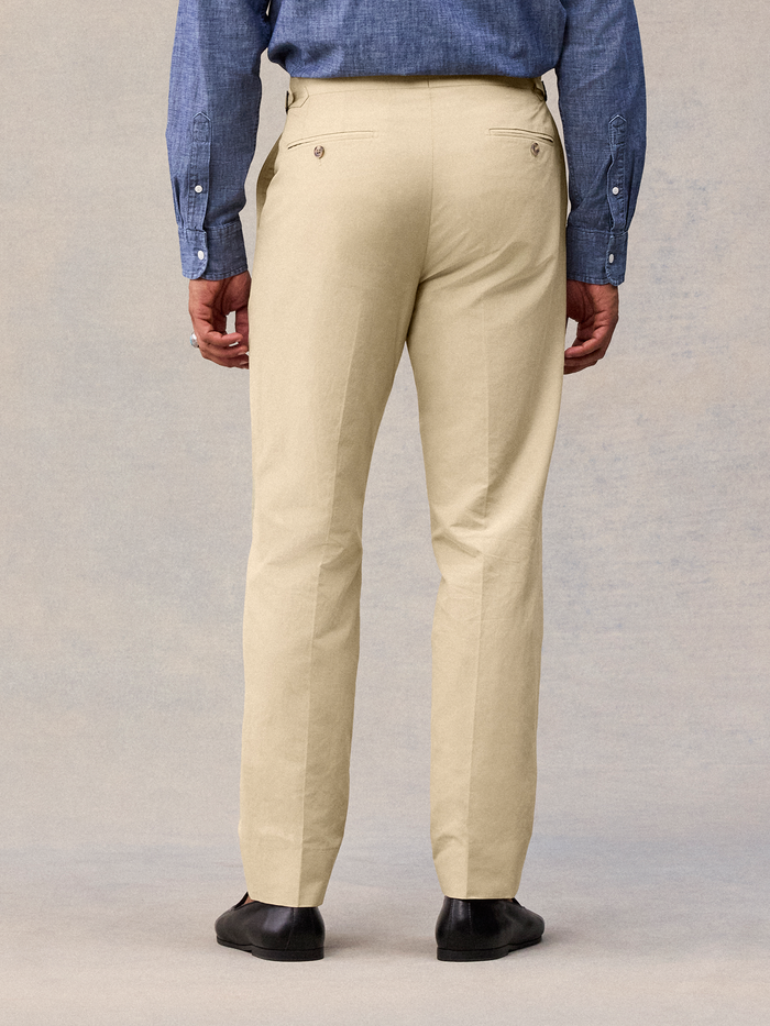 Harvest tan suit pant back view, cropped to show buttoned welt pockets and straight leg