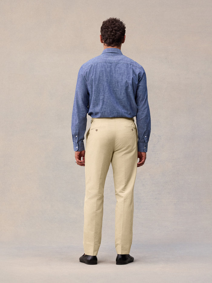Model in harvest tan suit pant and chambray shirt, full-length back view