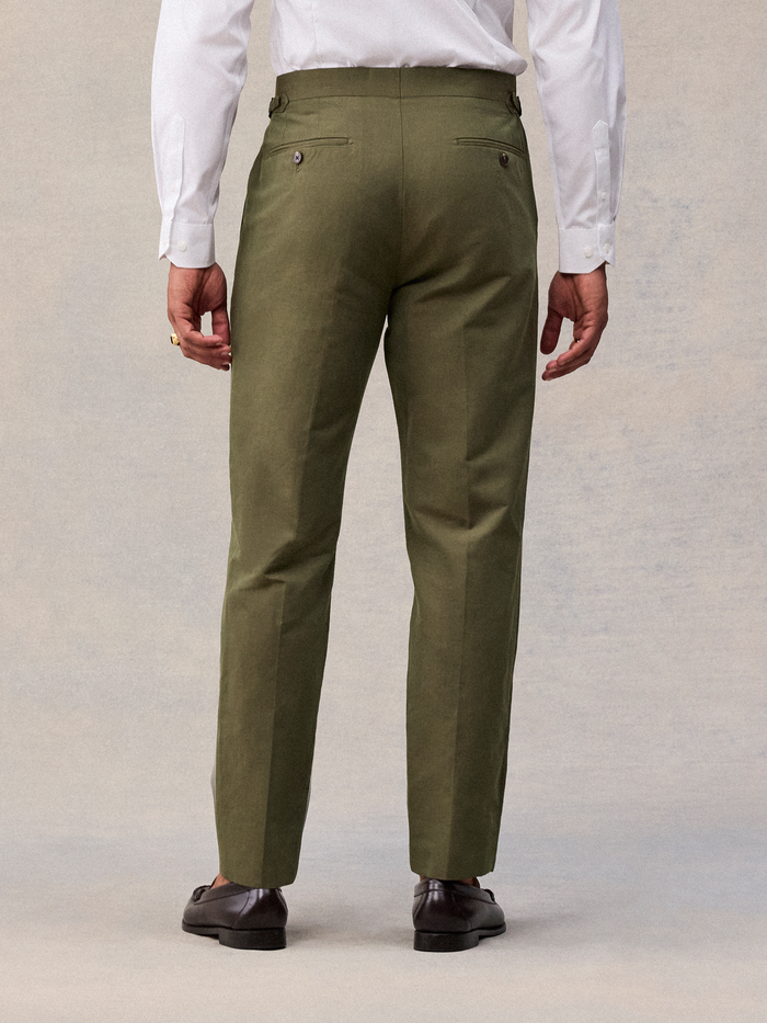 Vintage olive suit pant back view, cropped to show buttoned welt pockets and side tabs