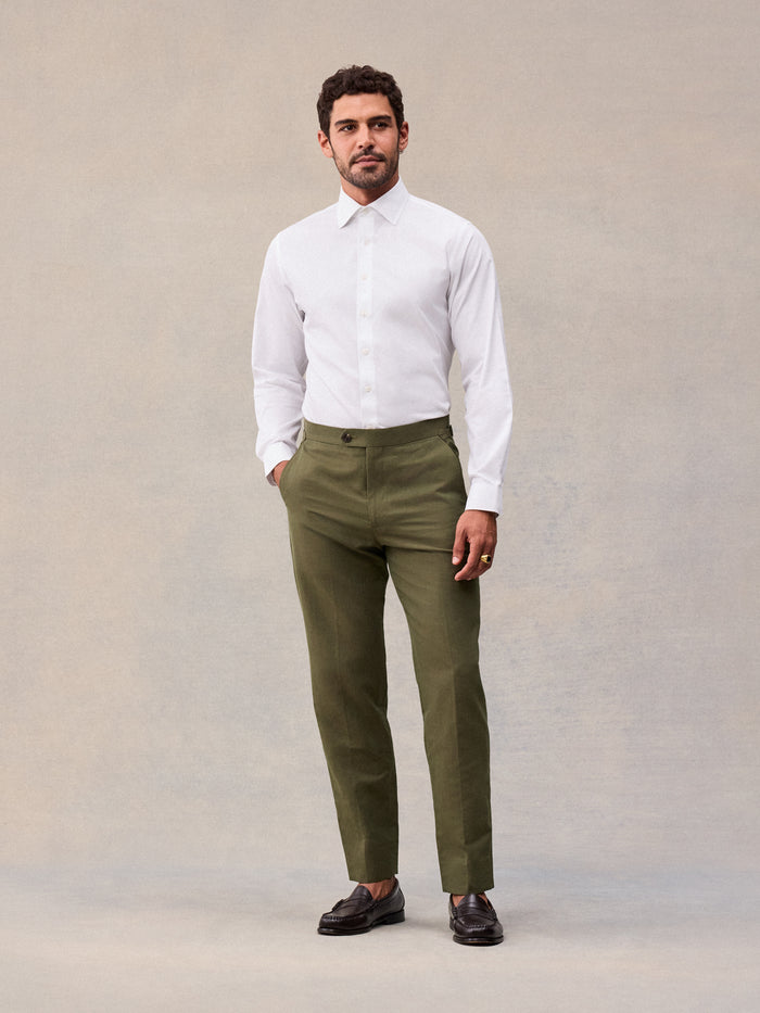 Model in vintage olive suit pant and white dress shirt, full-length front view
