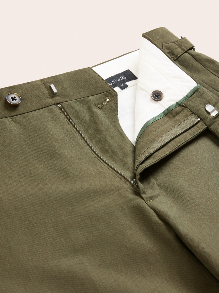Vintage olive suit pant waistband open to show zip fly, extended tab and inner lining