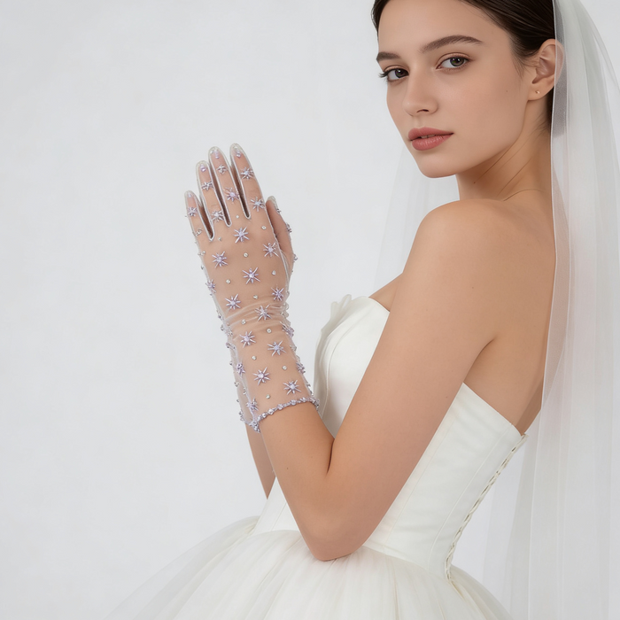 Bride wearing lavender crystal embellished tulle gloves with a wedding gown during an elegant bridal photoshoot.