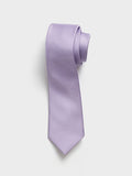 Lavender silk necktie with twill texture, rolled at the top on a grey background.