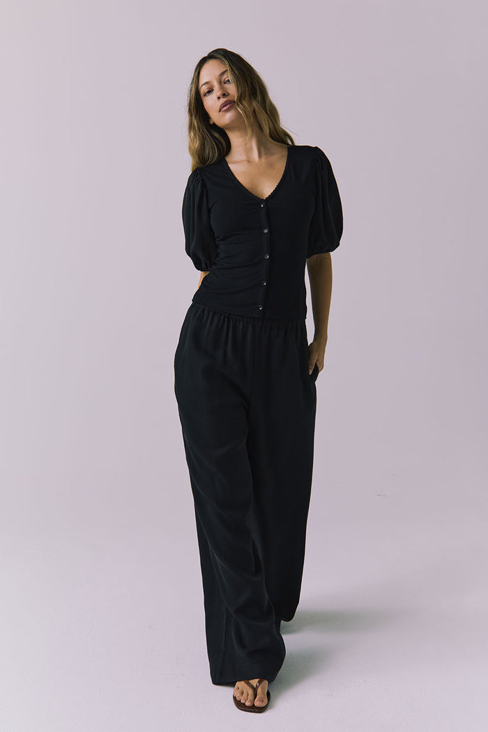 Chaser Abbie Black Blouse shown with matching Lee Trousers in a relaxed full body view as the model walks forward