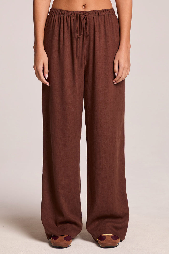 A front view of a woman wearing the Chaser  Lee Kahlua Trouser on a neutral background with brown shoes