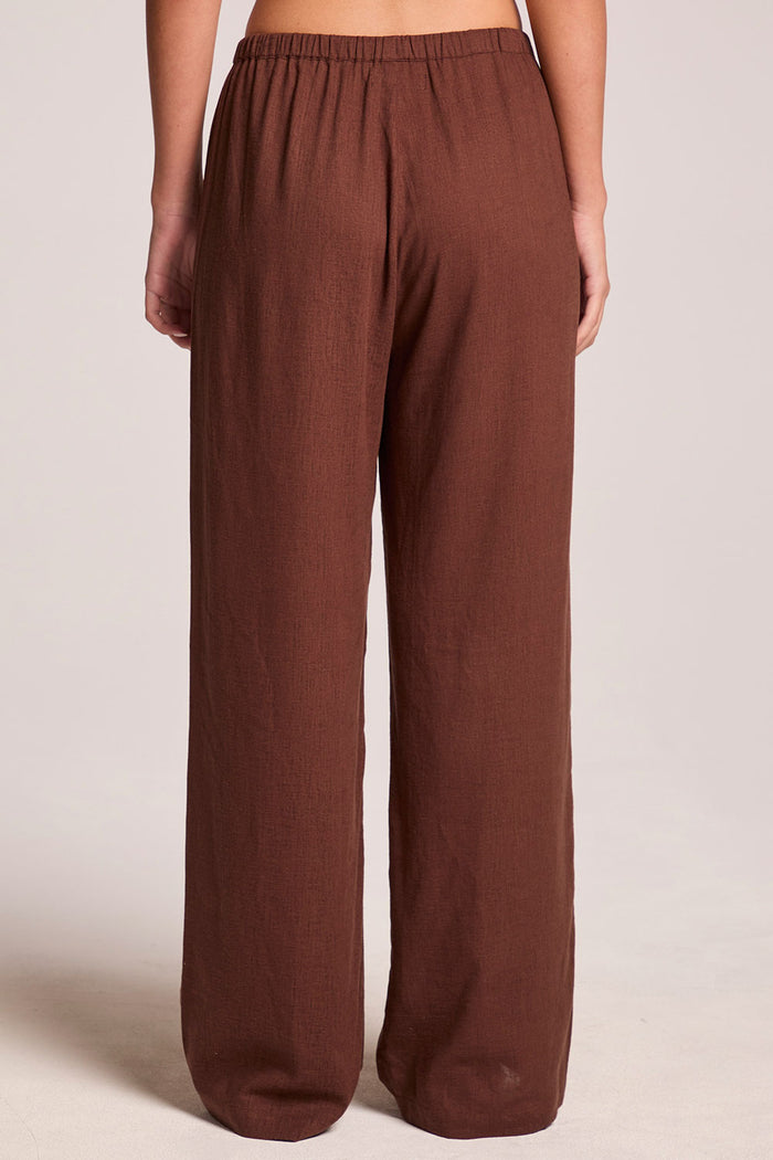 Back front view of a woman wearing the Chaser  Lee Kahlua Trouser on a neutral background with arms hanging down
