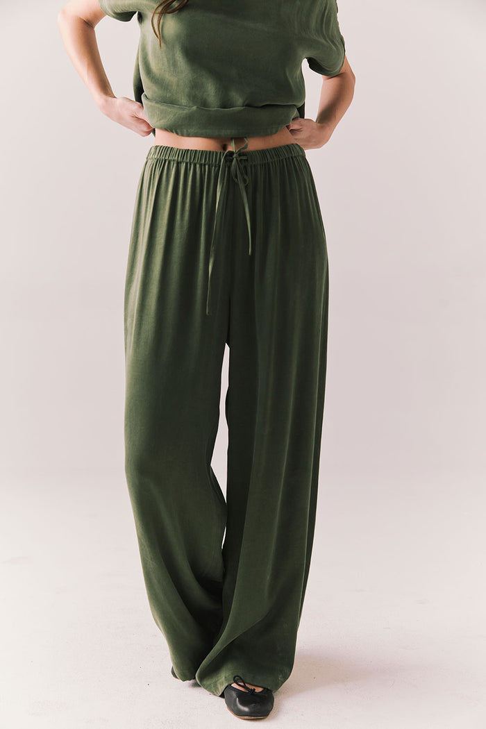Front view of Lee Trouser in bronze green with wide-leg silhouette and relaxed drape against a plain background