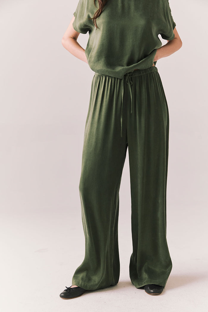 Front view of Lee Trouser in bronze green with wide-leg silhouette and relaxed drape against a plain background