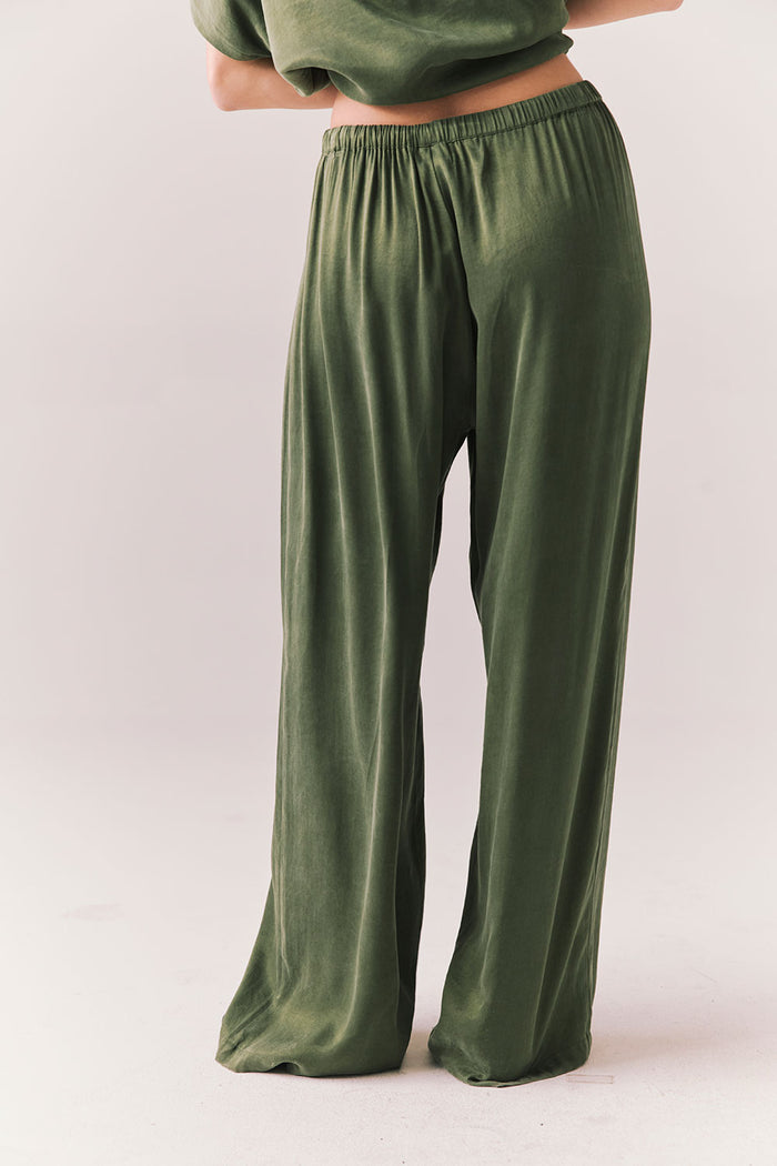 Back view of Lee Trouser in bronze green with wide-leg silhouette and relaxed drape against a plain background