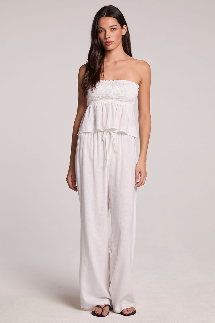 A full body front view of a woman wearing the Chaser Lee White Trouser on a neutral background