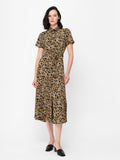 A woman wearing a short sleeved shirt dress with a gold and black floral print, short sleeves and a button front fastening.