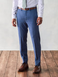 Cropped front view of light blue suit trousers with brown belt and shoes