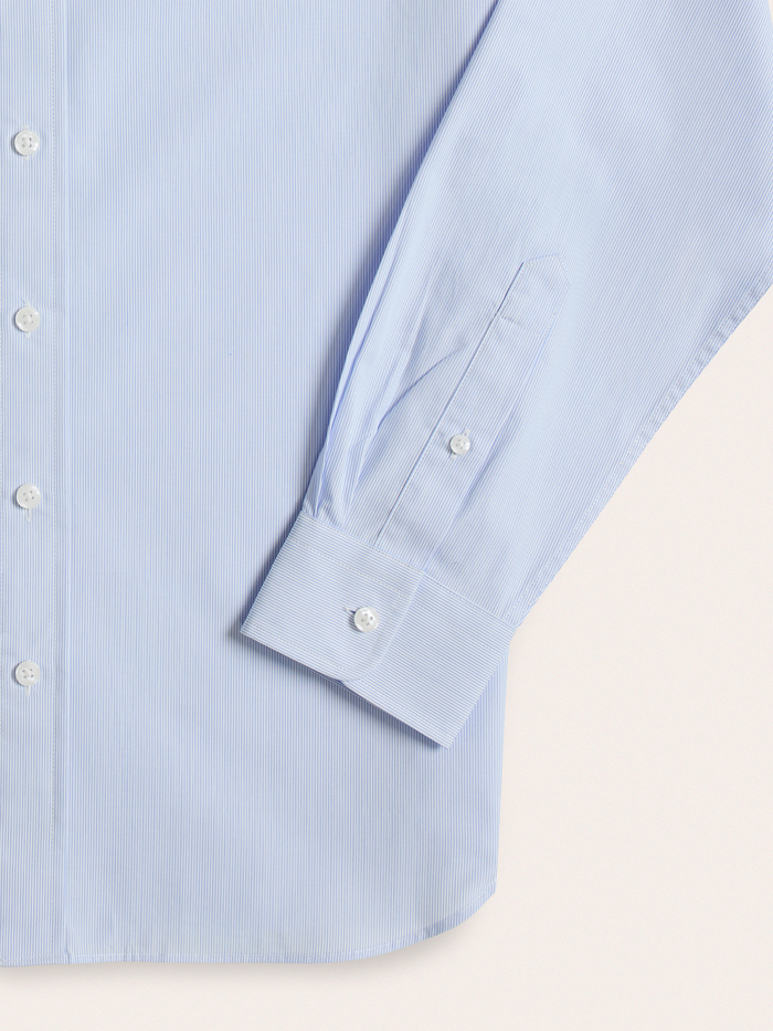 Close-up of light blue and white striped dress shirt cuff and sleeve placket
