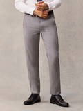 Cropped front view of light grey suit trousers with black belt and shoes