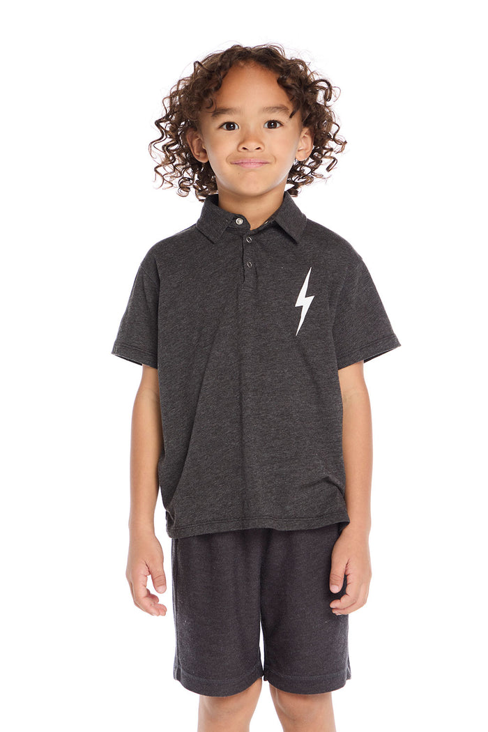 Front view of boy wearing the Chaser Kids dark gray Lightning Bolt Classic Tee with white lightning bolt graphic and matching shorts on a white background