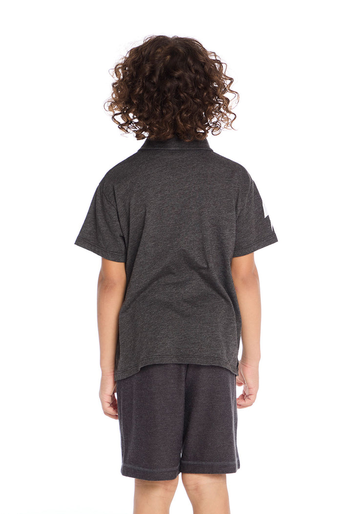 Back view of boy wearing the Chaser Kids dark gray Lightning Bolt Classic Tee and matching shorts on a white background