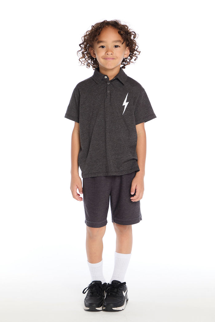 Full body view of boy wearing the Chaser Kids dark gray Lightning Bolt Classic Tee and matching shorts with black sneakers and white socks on a white background