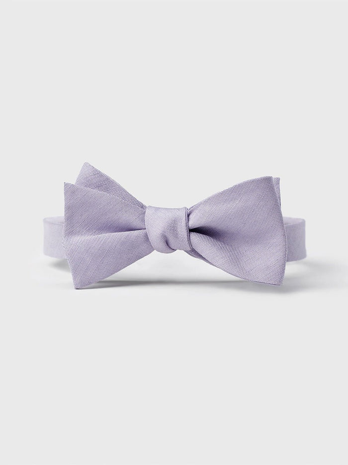 Lilac linen and silk pre-tied bow tie, front view on a grey background.