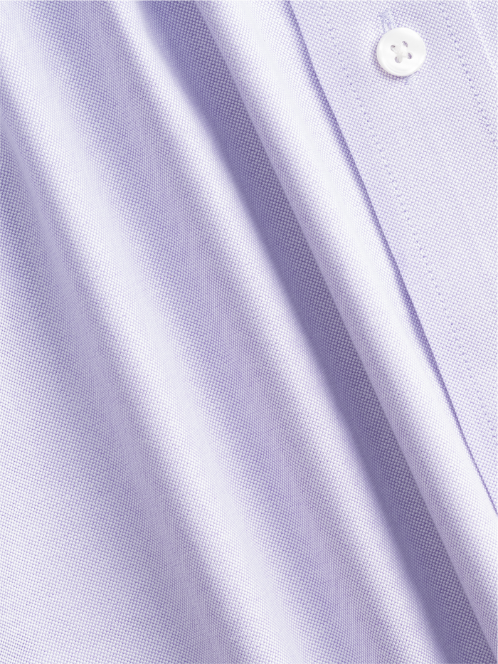 Close-up of lilac oxford shirt fabric with folds, showing woven texture