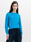 Woman wearing a purl knit regular fit jumper with a crew neck and long raglan sleeves.
