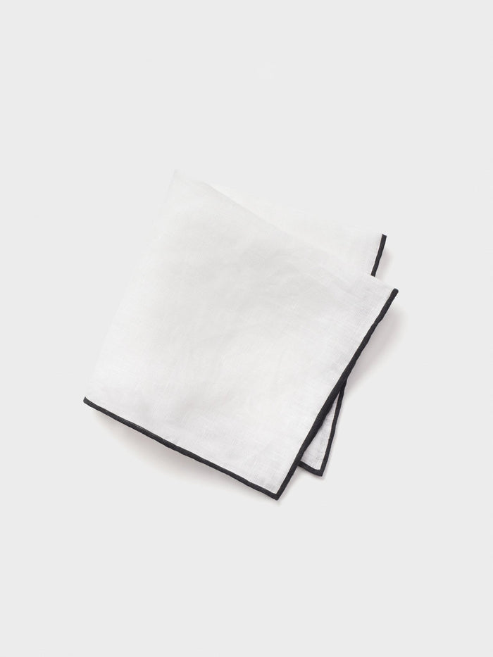 White linen pocket square with black border, folded on white background