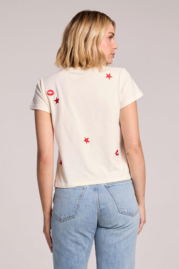 Back view of a woman wearing the Chaser Lips Embroidery Tee on a neutral background