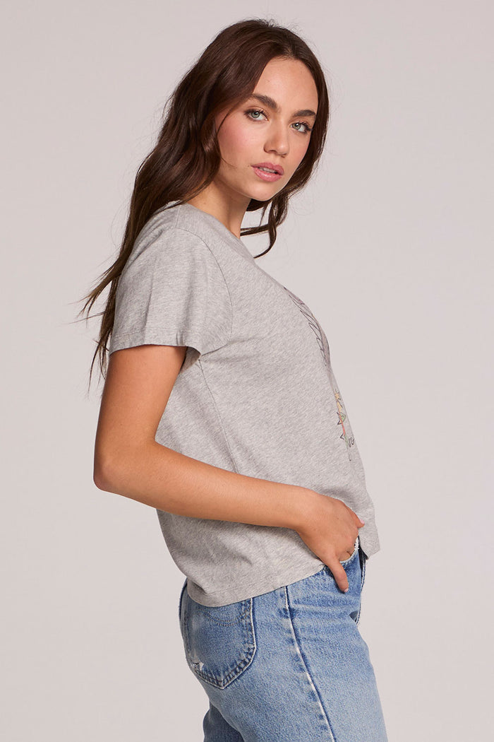 Side view of a woman wearing the Chaser  Live Music Graphic Tee and jeans on a neutral background