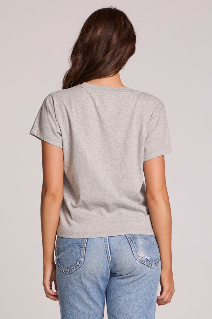 Back view of a woman wearing the Chaser  Live Music Graphic Tee and blue jeans on a neutral background