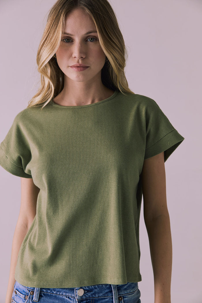 Centered front view of Chaser Brand Liza Meadow Green Tee styled with light denim for a casual everyday look
