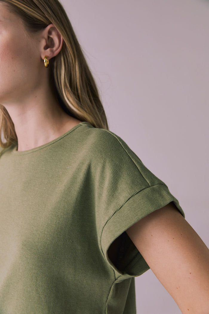 Close-up of Chaser Brand Liza Meadow Green Tee focusing on sleeve cuff and rib-knit fabric texture