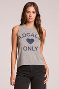 Front view of a woman wearing the Chaser  Locals Only Tee and jeans on a neutral background