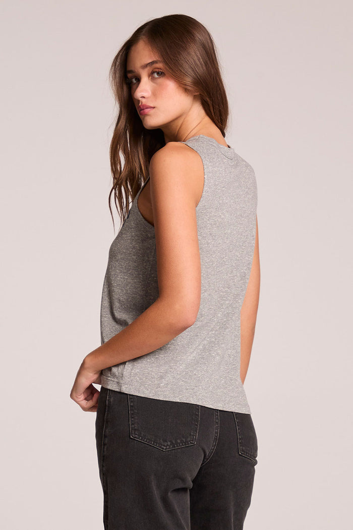 Back view of a woman wearing the Chaser  Locals Only Tee on a neutral background