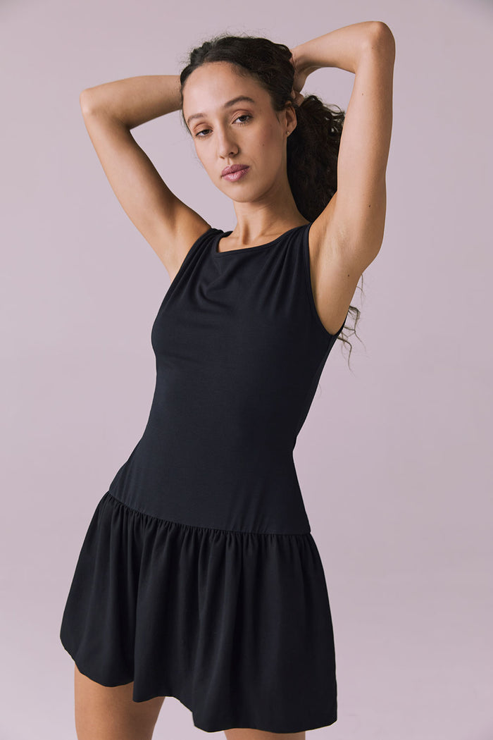 Front angle of Chaser Brand Lou Licorice Black Mini Dress showing smooth fit and drop waist detail