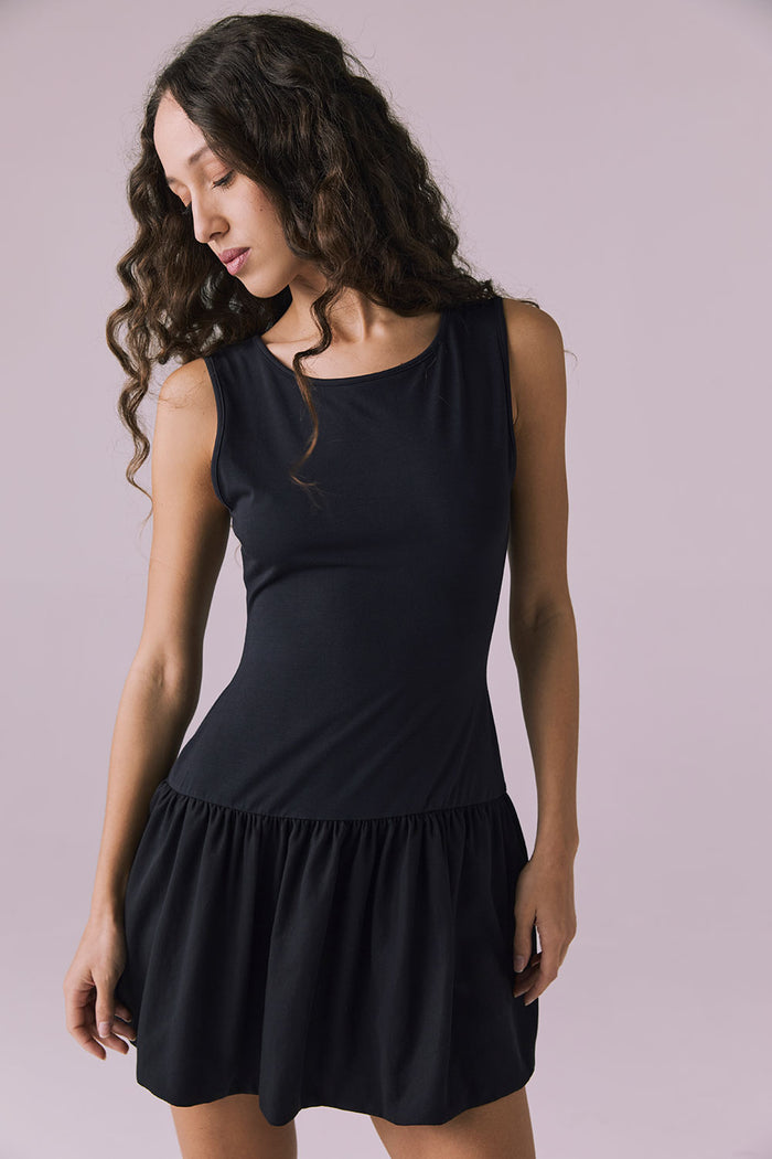 Front angle of Chaser Brand Lou Licorice Black Mini Dress showing smooth fit and drop waist detail