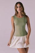 Front full body view of Chaser Brand Lou Meadow Green Mini Dress highlighting the clean sleeveless bodice and soft off white mini skirt