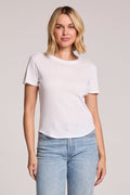 Front view of a woman wearing the Chaser Louisa White Tee and jeans on a neutral background