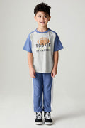 Full body front view of a boy wearing the Chaser Lounge Pants Boys Shamu Jogger on a neutral background with Rookie tee shirt