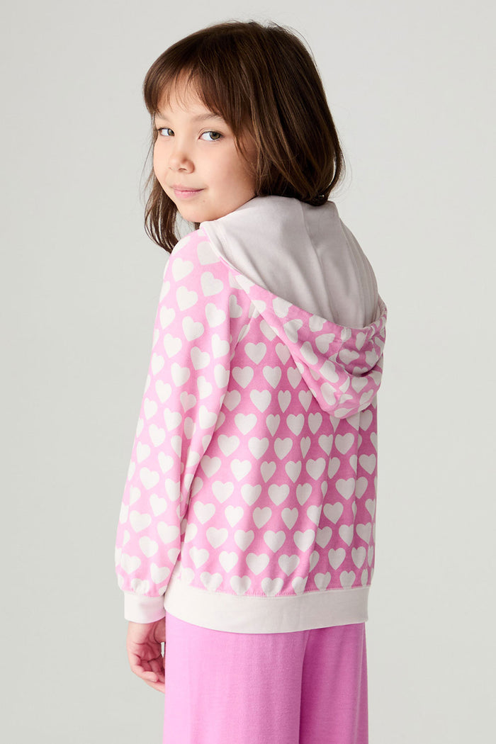 Back view of a girl wearing the Chaser  Love Is Everywhere Girls Hoodie and matching pink pants looking over shoulder