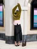 A woman wearing a green fluffy knit jumper with a crew neck, long sleeves and a relaxed fit.
