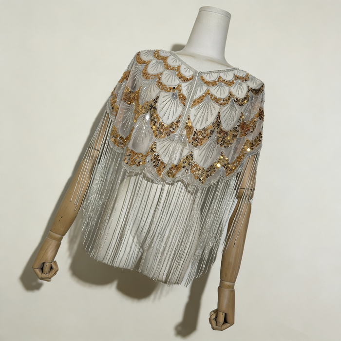 Luxury handcrafted bridal capelet with shimmering sequins, bead embroidery and flowing fringe in elegant ivory.